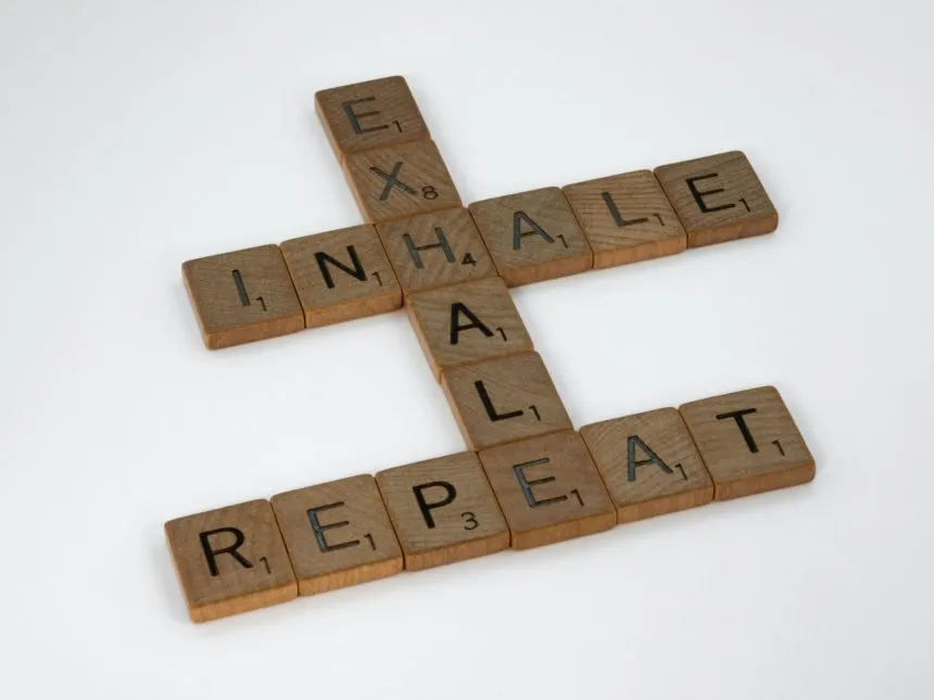 Scrabble tiles spelling “inhale, exhale, repeat” — a breathing and stress-relief motif